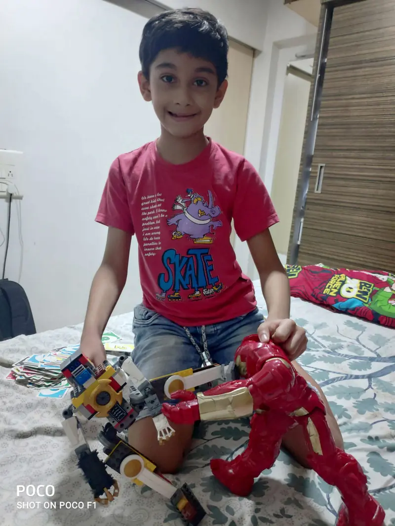 Dhairya with his Lego robot and Iron Man figure